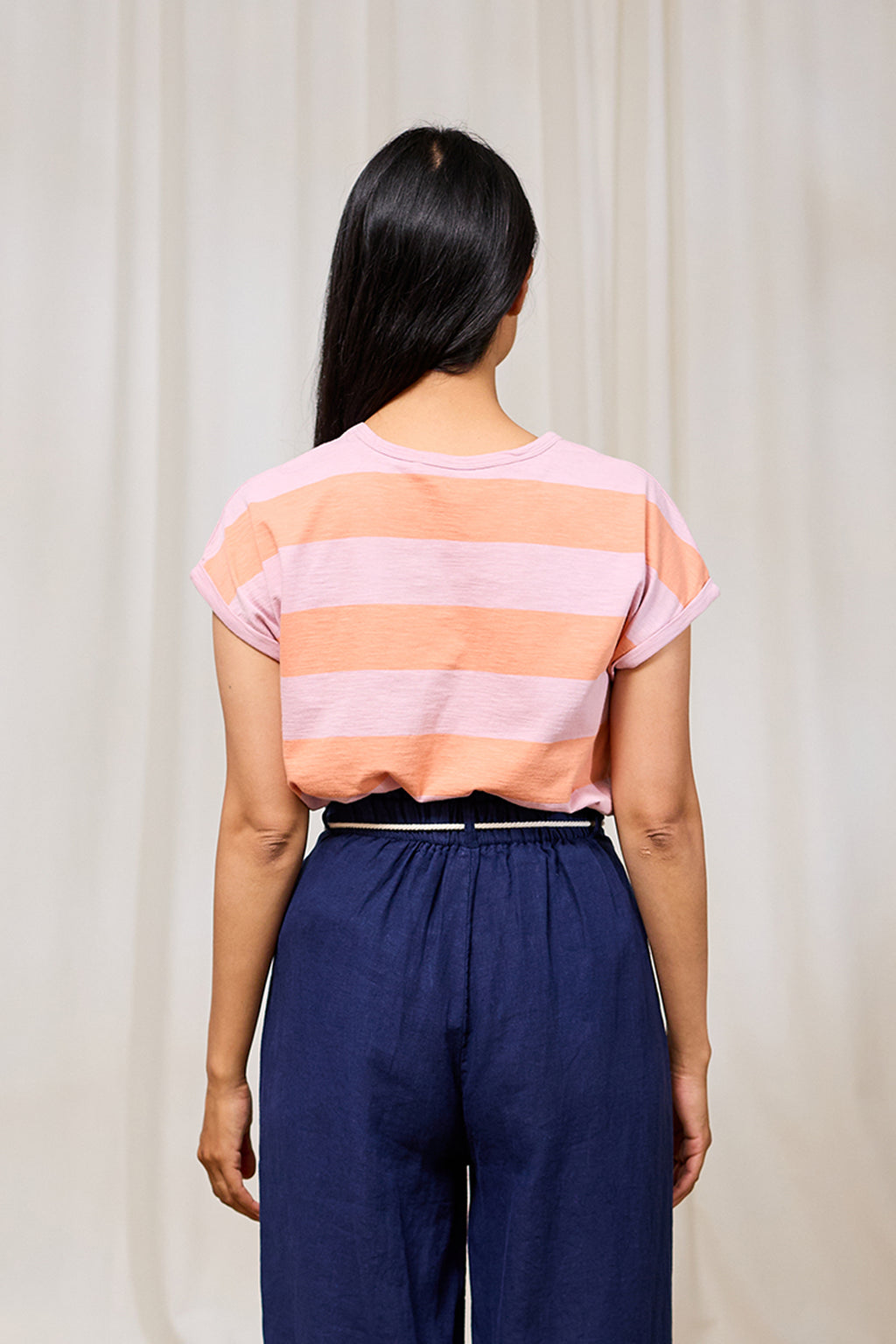 T-shirt sans manches Santandria de TwoThirds rayé rose et orange, avec logo de la marque Wal brodé sur la poitrine gauche, vue de dos sur le mannequin