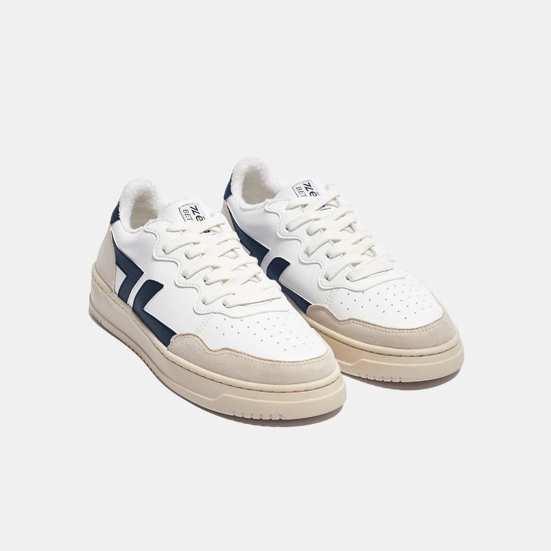Zeta Marino B1 weiße Sneaker mit blauen Seitenstreifen, hellgrauen Front- und Sohlenstreifen und weißer Sohle, seitliche Frontansicht